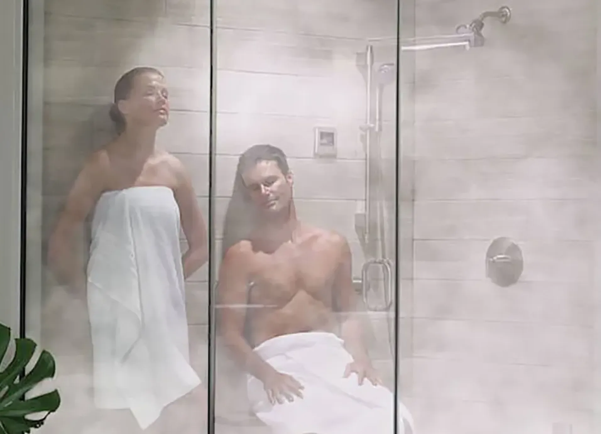 steam-shower-installation-bathroom-upgrade-calgary Technician installing a steam shower in a Calgary bathroom during a renovation